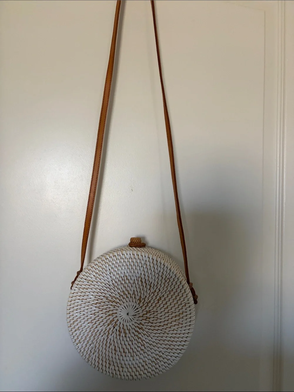 Round Straw Crossbody Bag with Yellow Floral Embroidery. 8x8 in., 24in strap